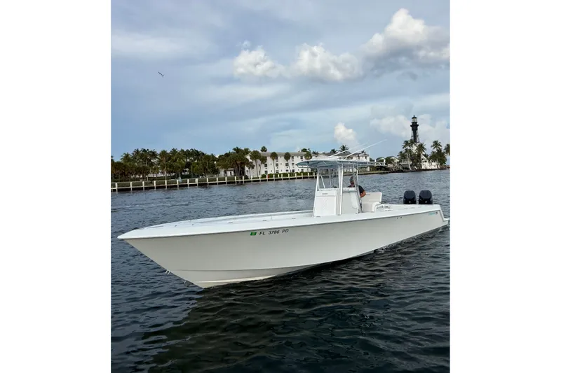Slide: The Image of 2011 Contender 35 ST boat on water near a lighthouse and palm trees. - 6