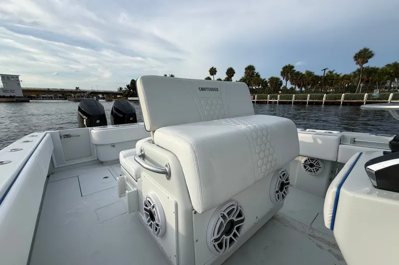 Slide: The Image of 2011 Contender 35 ST boat interior with white seating and dual Mercury outboard engines. - 14