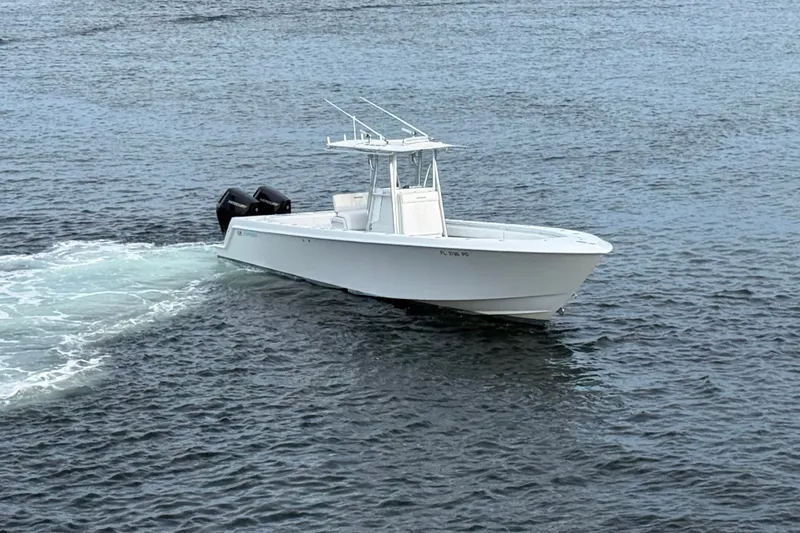 Slide: The Image of 2011 Contender 35 ST boat cruising on open water, showcasing sleek design and powerful engines. - 3