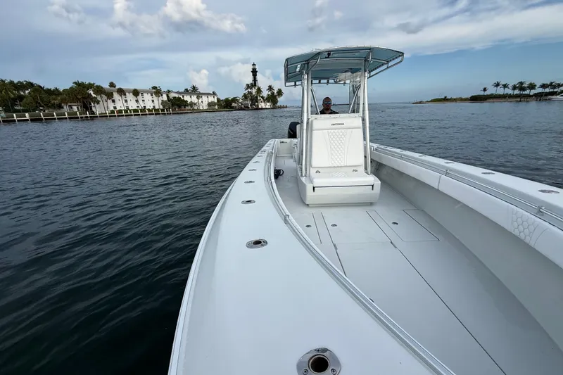 Slide: The Image of 2011 Contender 35 ST boat cruising on calm waters near a coastal area. - 9