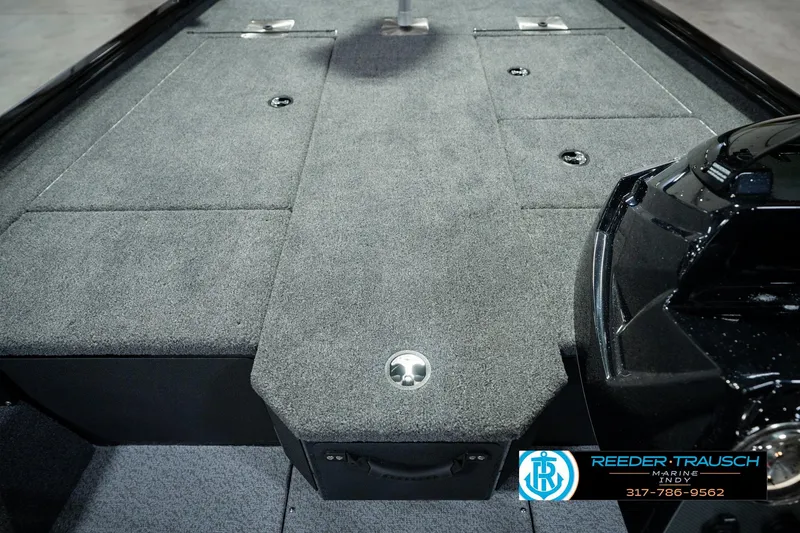 Slide: The Image of 2026 Lund 1875 Renegade boat interior with carpeted deck and storage compartments. - 28