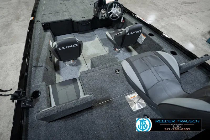 Slide: The Image of 2026 Lund 1875 Renegade boat interior with seating and steering wheel, showcased by Reeder-Trausch Marine. - 16