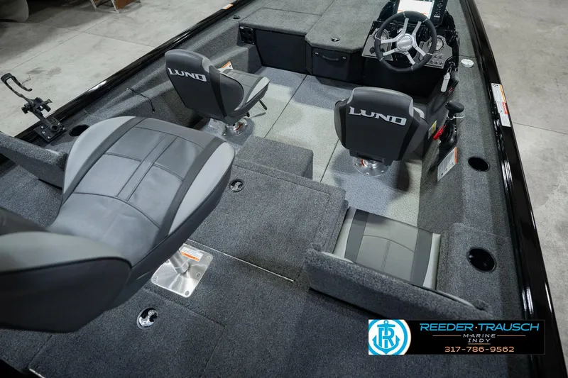 Slide: The Image of 2026 Lund 1875 Renegade boat interior with seating and steering console. - 14