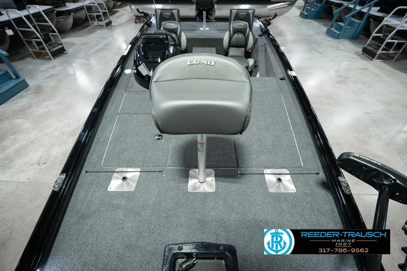 Slide: The Image of 2026 Lund 1875 Renegade boat interior with gray seating and carpeted deck. - 21