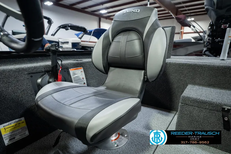 Slide: The Image of 2026 Lund 1875 Renegade boat seat in showroom, featuring sleek design and comfortable upholstery. - 42