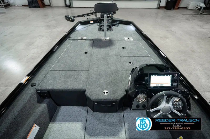 Slide: The Image of 2026 Lund 1875 Renegade boat interior with steering console and seating, showcased by Reeder-Trausch Marine. - 18