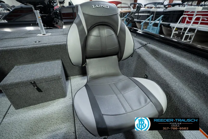 Slide: The Image of 2026 Lund 1875 Renegade boat seat with gray upholstery in showroom setting. - 44