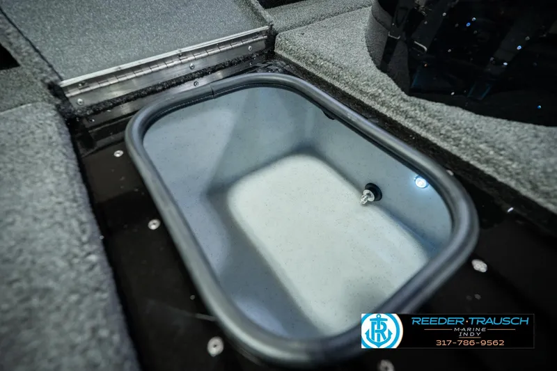 Slide: The Image of 2026 Lund 1875 Renegade boat interior storage compartment with carpeted finish. - 50