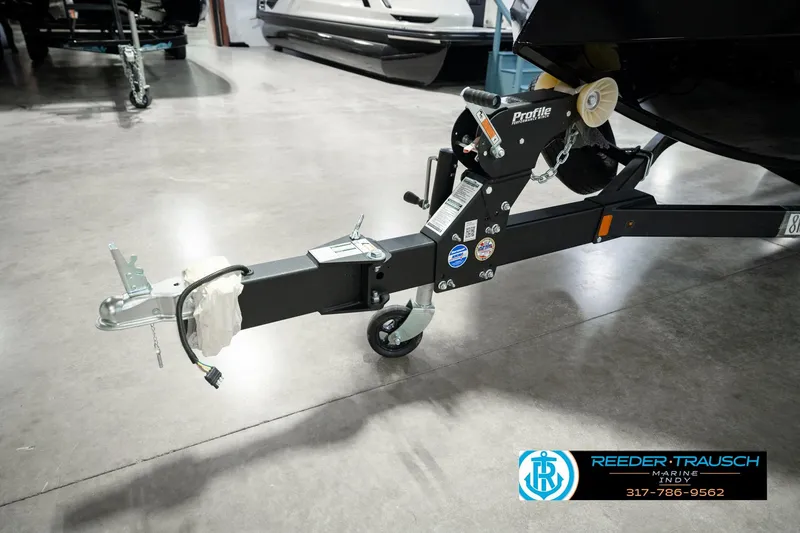 Slide: The Image of Trailer hitch of 2026 Lund 1875 Renegade boat in showroom setting. - 61
