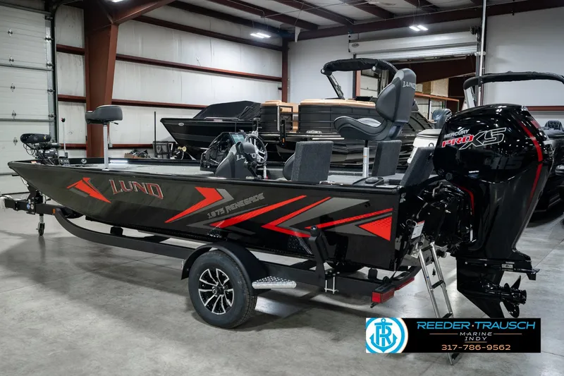 Slide: The Image of 2026 Lund 1875 Renegade fishing boat with Mercury Pro XS engine in showroom. - 9