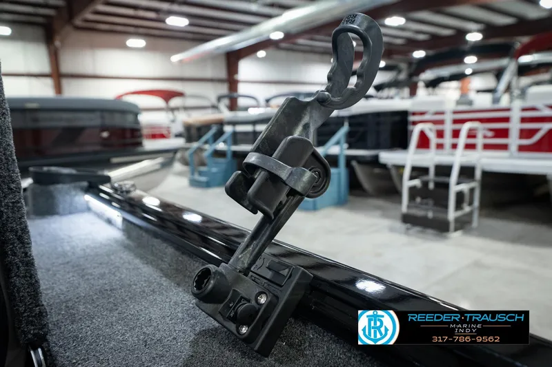 Slide: The Image of 2026 Lund 1875 Renegade boat detail in showroom with marine equipment. - 49