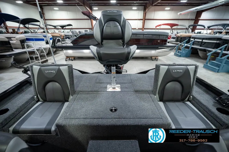 Slide: The Image of 2026 Lund 1875 Renegade boat interior with seating, displayed in a showroom. - 24