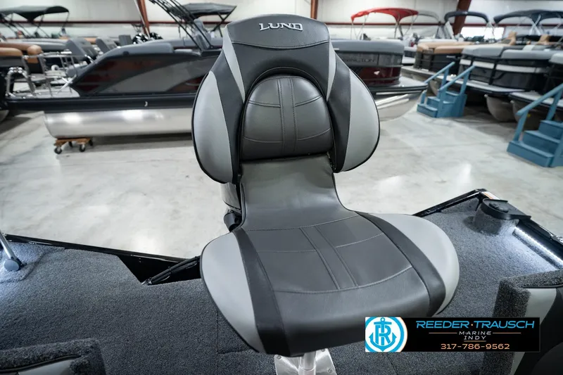 Slide: The Image of 2026 Lund 1875 Renegade boat seat in showroom, featuring sleek black and gray design. - 46