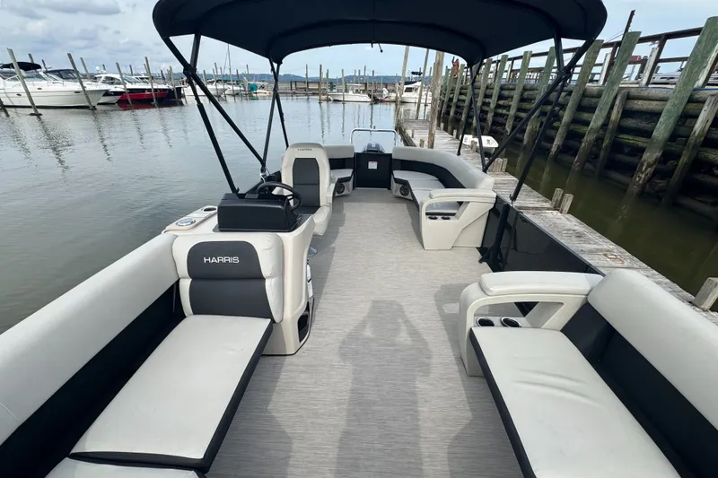Slide: The Image of 2024 Harris Breeze 230 pontoon boat interior at marina dock. - 4