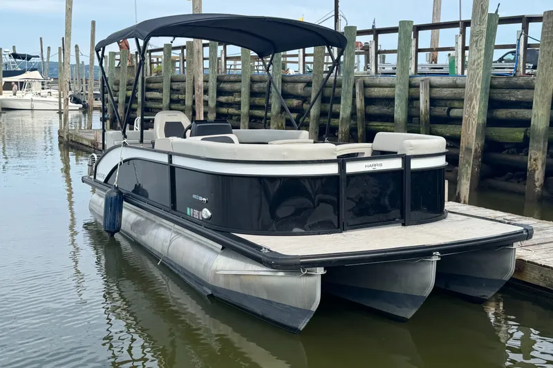 Slide: The Image of 2024 Harris Breeze 230 pontoon boat docked in marina. - 3