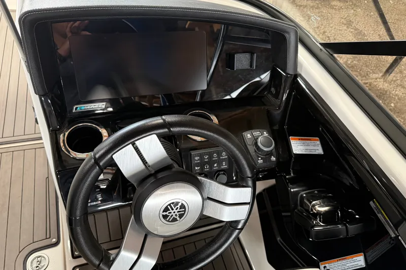 Slide: The Image of 2018 Yamaha Boats 242X E-Series dashboard with steering wheel and controls. - 5
