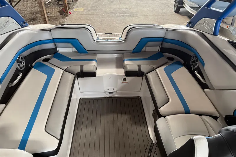 Slide: The Image of 2018 Yamaha Boats 242X E-Series interior with blue and gray seating, showcasing spacious design. - 6