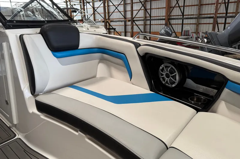 Slide: The Image of 2018 Yamaha Boats 242X E-Series interior with blue and white seating and speaker system. - 8