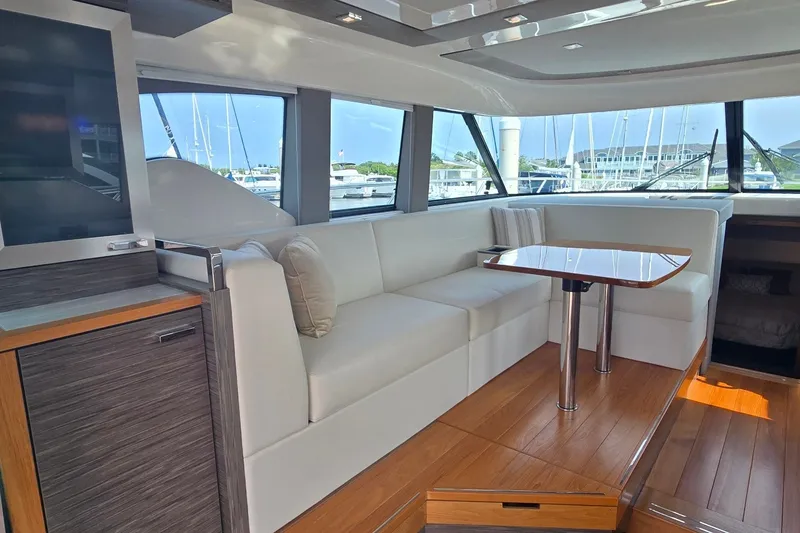 Slide: The Image of Luxurious interior of 2021 Tiara Yachts F44 Flybridge with elegant seating and wooden flooring. - 14