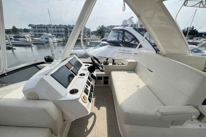 Slide: The Image of Interior view of 2021 Tiara Yachts F44 Flybridge, featuring helm and seating area. - 42