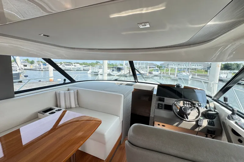 Slide: The Image of Interior of 2021 Tiara Yachts F44 Flybridge with helm and seating area. - 12
