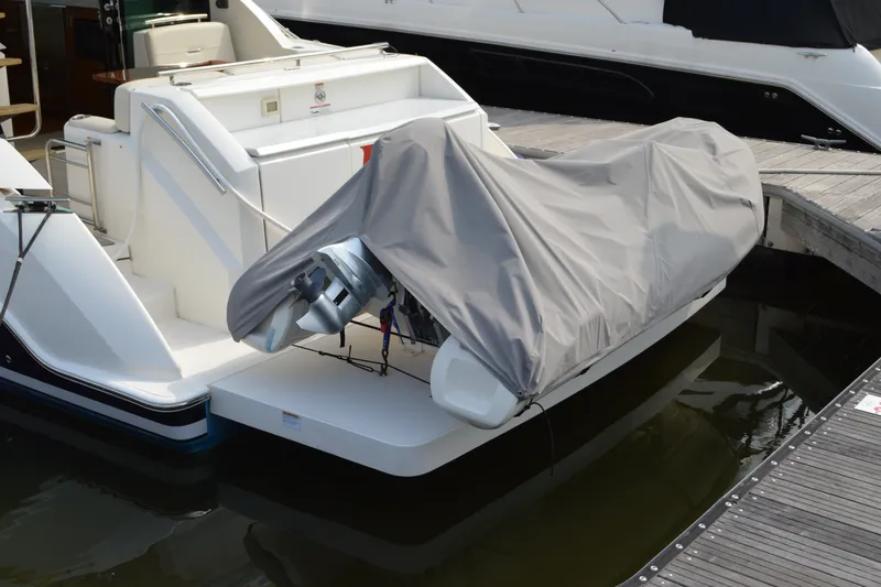 Slide: The Image of 2021 Tiara Yachts F44 Flybridge docked, featuring covered outboard motor. - 58