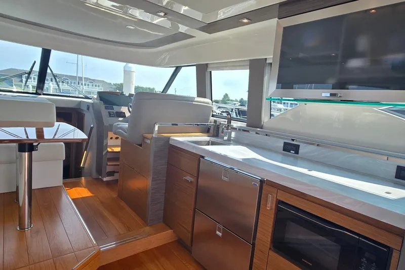 Slide: The Image of Luxurious interior of 2021 Tiara Yachts F44 Flybridge with modern kitchen and seating area. - 17