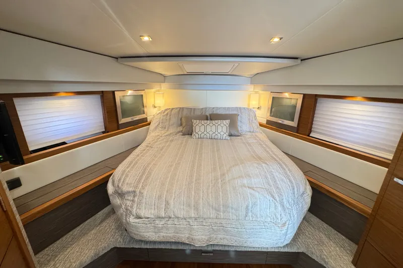 Slide: The Image of Luxurious 2021 Tiara Yachts F44 Flybridge cabin with elegant bedding and modern lighting. - 25