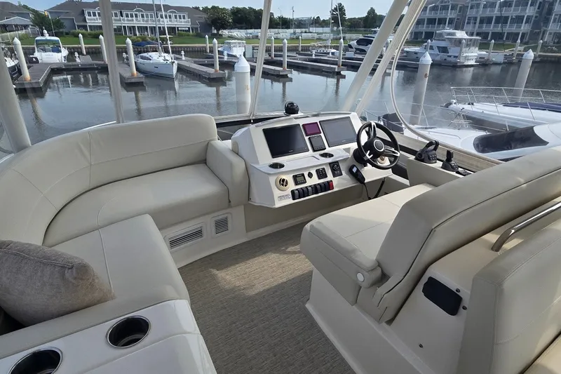 Slide: The Image of Flybridge of 2021 Tiara Yachts F44, featuring luxurious seating and modern controls at marina. - 40