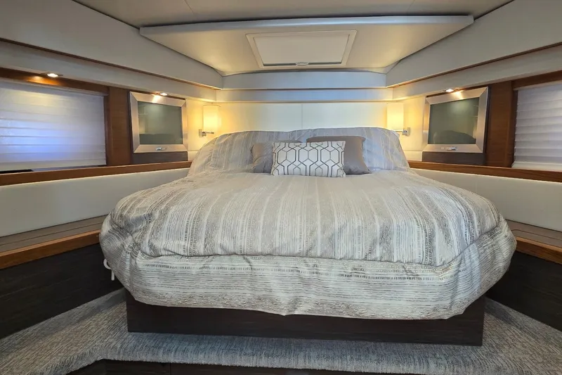 Slide: The Image of Luxurious bedroom interior of 2021 Tiara Yachts F44 Flybridge with elegant bedding. - 26