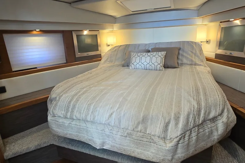 Slide: The Image of Luxurious bedroom interior of 2021 Tiara Yachts F44 Flybridge with elegant bedding and ambient lighting. - 28