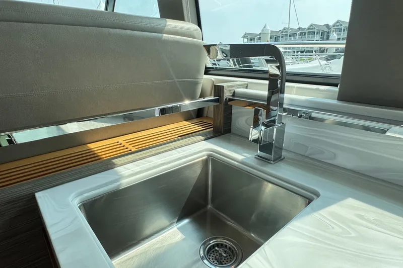 Slide: The Image of Modern kitchen sink on 2021 Tiara Yachts F44 Flybridge, featuring sleek design and chrome faucet. - 24