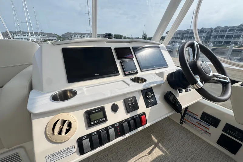 Slide: The Image of Helm of 2021 Tiara Yachts F44 Flybridge with modern navigation displays and controls. - 43