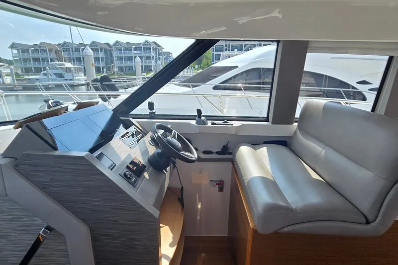 Slide: The Image of Interior helm of 2021 Tiara Yachts F44 Flybridge with modern controls and seating. - 19