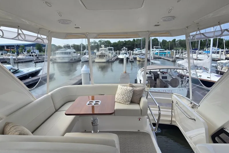 Slide: The Image of Luxurious 2021 Tiara Yachts F44 Flybridge interior with marina view. - 50