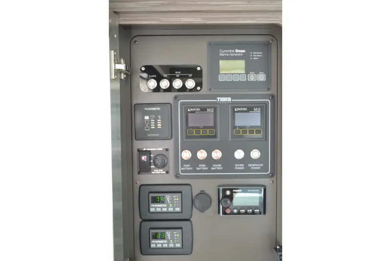 Slide: The Image of Control panel of 2021 Tiara Yachts F44 Flybridge with generator and battery indicators. - 59