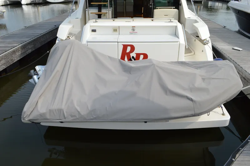 Slide: The Image of 2021 Tiara Yachts F44 Flybridge with covered equipment at marina dock. - 57