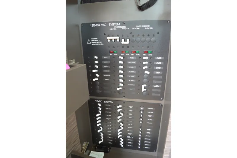 Slide: The Image of Electrical panel on a 2021 Tiara Yachts F44 Flybridge, showcasing 120/240VAC and 12VDC systems. - 60