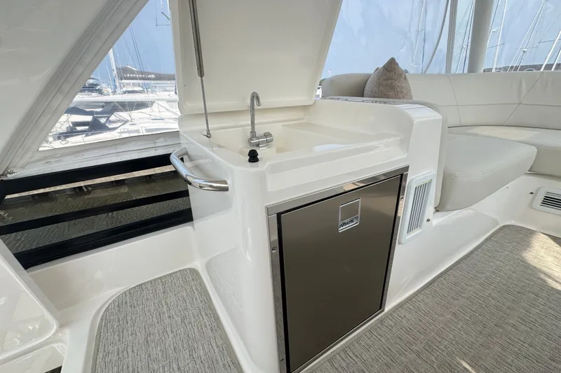 Slide: The Image of 2021 Tiara Yachts F44 Flybridge interior with sink and seating area. - 51