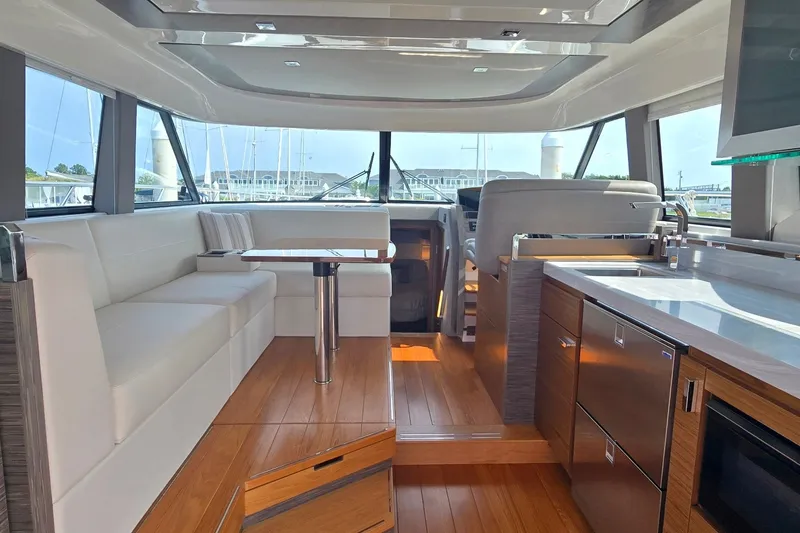 Slide: The Image of Luxurious interior of 2021 Tiara Yachts F44 Flybridge with modern kitchen and seating area. - 13