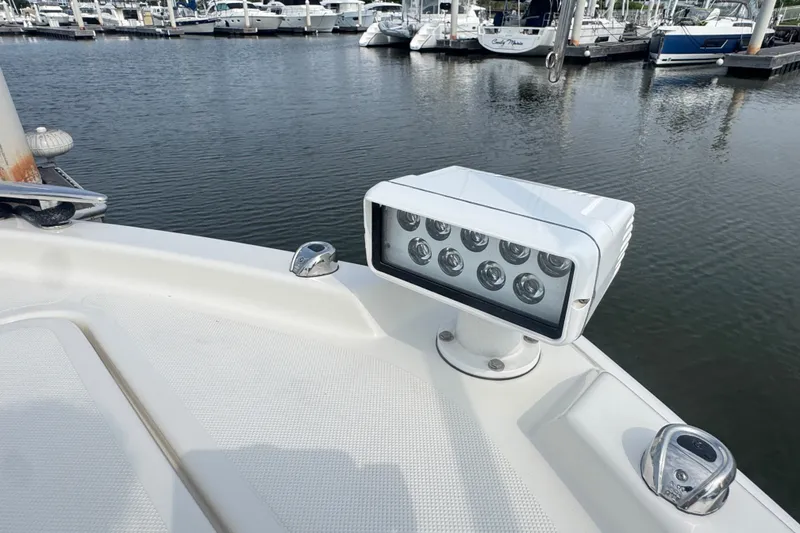 Slide: The Image of Tiara Yachts F44 Flybridge 2021 spotlight on deck, docked at marina. - 10