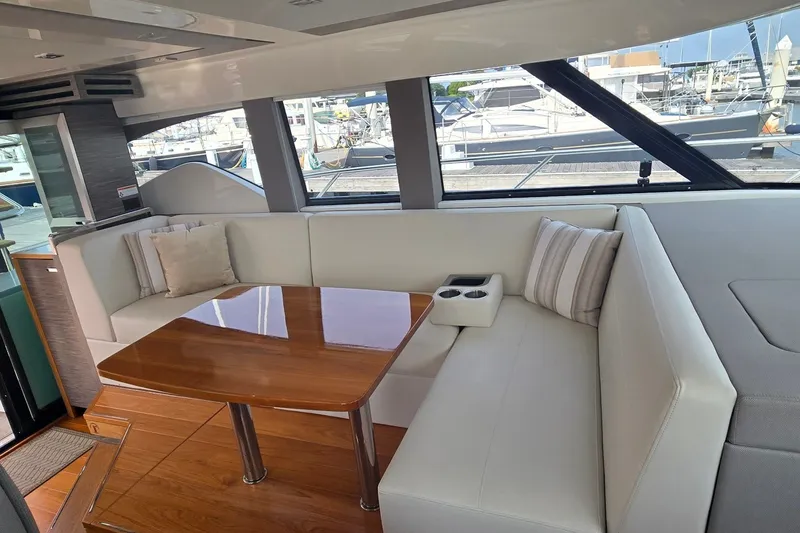 Slide: The Image of Luxurious interior of 2021 Tiara Yachts F44 Flybridge with plush seating and wooden table. - 16