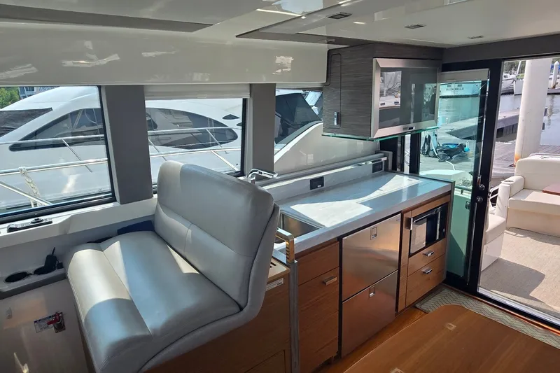 Slide: The Image of Luxurious interior of 2021 Tiara Yachts F44 Flybridge with modern kitchen and seating area. - 18