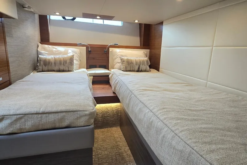 Slide: The Image of Luxurious twin cabin interior of 2021 Tiara Yachts F44 Flybridge, featuring elegant bedding. - 31