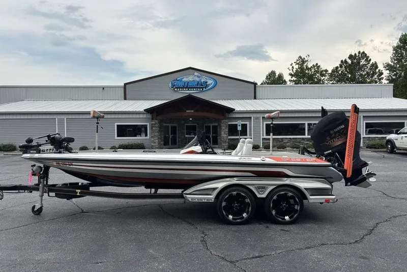 The Image of 2018 Skeeter FX21 boat parked outside a marine center on a trailer. - 1