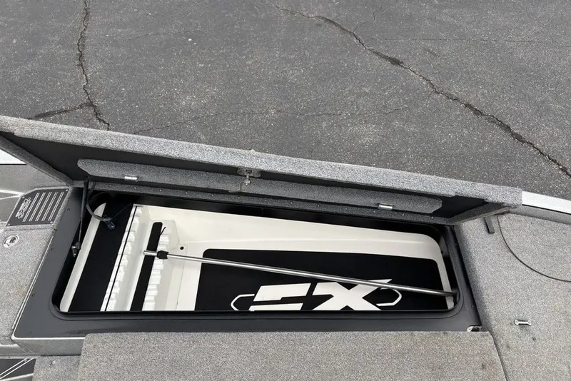 Slide: The Image of 2018 Skeeter FX21 boat storage compartment with open lid, showcasing interior space. - 23