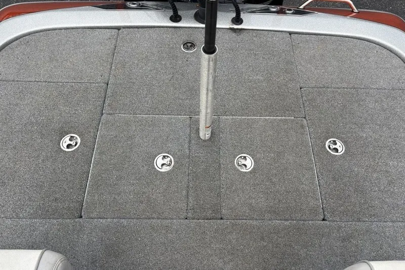 Slide: The Image of 2018 Skeeter FX21 boat deck with gray carpet and storage compartments. - 31