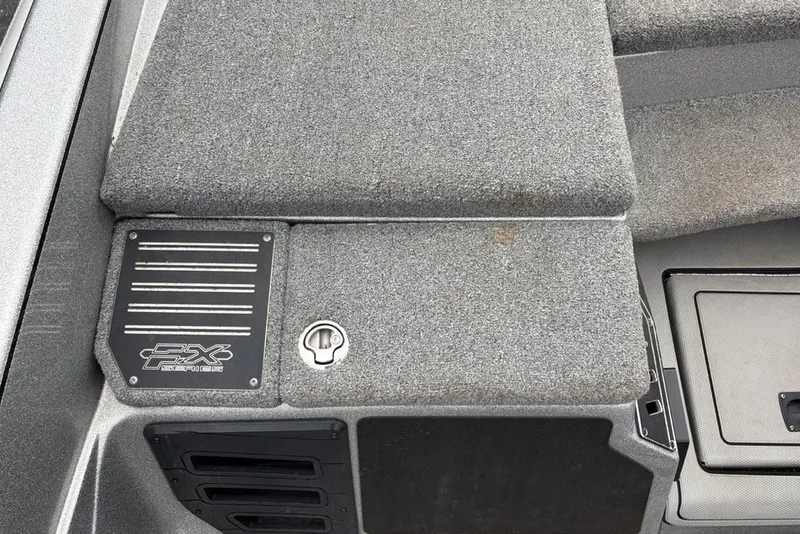 Slide: The Image of 2018 Skeeter FX21 boat deck with carpeted surface and storage compartment. - 21