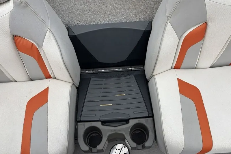 Slide: The Image of 2018 Skeeter FX21 boat interior with gray and orange seats, featuring a central console. - 33
