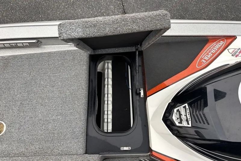 Slide: The Image of 2018 Skeeter FX21 boat storage compartment with Power-Pole branding and carpeted interior. - 24